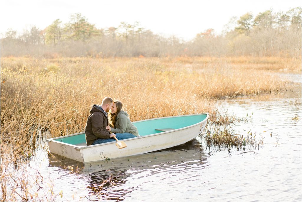 couple in boat at sunset engagement photo
